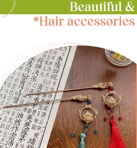 Detailed close-up of golden Chinese hairpins with lotus motifs and colorful silk tassels