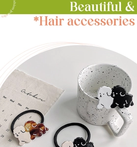 Close-up of cute bichon puppy acetate hair ties in white black and tortoiseshell colors