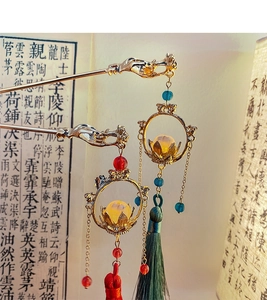 Detail view of vintage Chinese palace lantern hairpins with silk tassels and lotus charms