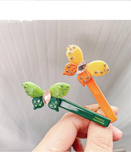 Detailed macro view of handmade butterfly hair clips with crystals and France handmade stamp