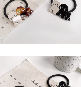 Detail of high-elasticity hair ties featuring cute acetate dog charms in multiple colors
