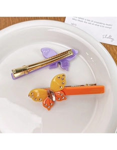 Detailed close-up of handmade butterfly acetate hair clips with crystal inlay and metal clip