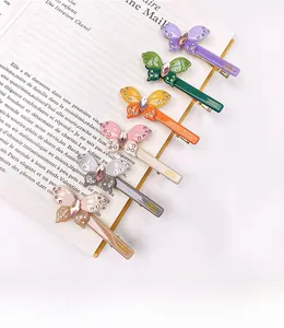Detailed set of six acetate butterfly hair clips with shimmering crystal accents