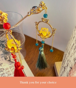 Detailed shot of a Chinese vintage gold hair stick with lotus petals and silk tassels