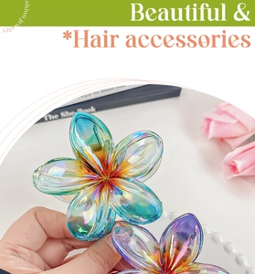 Macro detail of holographic plumeria hair claw clip with iridescent acrylic finish