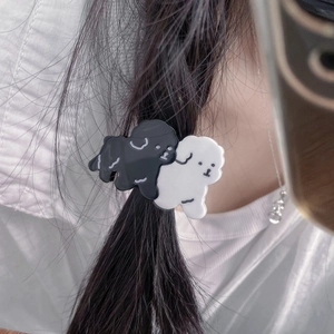 Cute black and white puppy dog acetate elastic hair tie worn on a ponytail