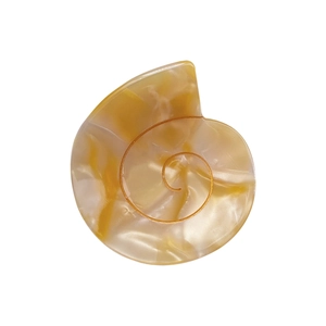 Minimalist shell-shaped cellulose acetate hair claw clip with amber marble texture