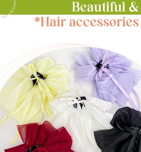 Detail view of large chiffon bow hair claws in five colors including purple and black