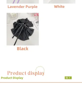 Detailed close-up of large elegant satin ribbon hair claw clips in black and lilac