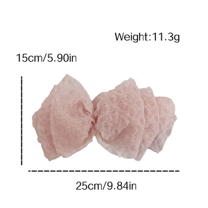 Pink seersucker oversized bow hair clip with spring fastener measuring 25cm by 15cm