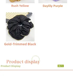Close-up of hair scrunchies in reed yellow, purple, and black with gold edge details
