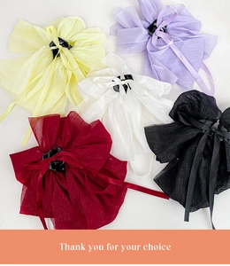 Flat lay of large chiffon bow hair claws in yellow, purple, white, red and black