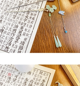 Detail of Chinese style hair stick with green ginkgo leaf and blue auspicious cloud tassel