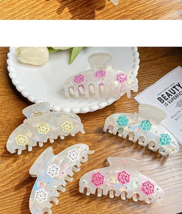 Macro shot of 5pcs iridescent hair claws with colorful floral accents and tiny rhinestones