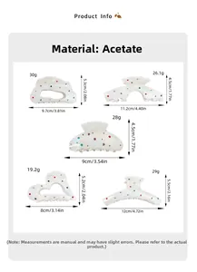 Détail de diverses pinces à cheveux en acétate irisé ornées de strass colorés brillants