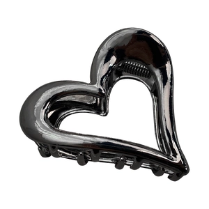 Hollow heart-shaped metal hair claw clip in glossy black finish for elegant hairstyling