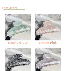 Detailed view of four large marble pattern hair claws in blue, pink, grey, and purple colors