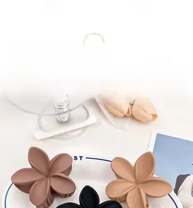 Detailed macro view showing the matte texture of assorted elegant floral hair claw clips