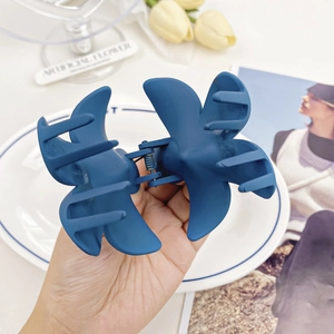 Matte navy blue plumeria hair claw clip for women featuring elegant flower petal design