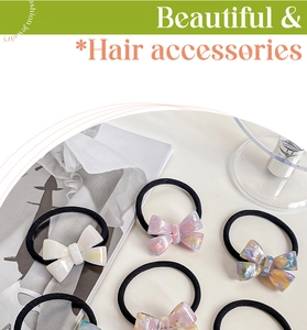 Detail of premium acetate bow hair ties featuring marble texture and high elastic bands