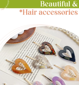 Detailed macro view of heart-shaped acetate hair clips with gold France Handmade logo