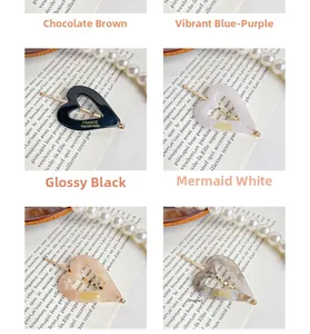 Detailed macro view of heart-shaped acetate hair clips with golden France handmade logo