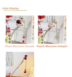 Detail of red plum and pink peach blossom hairpins with elegant gold tassels