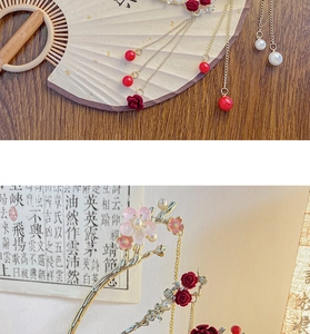 Macro detail of red rose and white pearl tassel on golden Chinese style hair pin