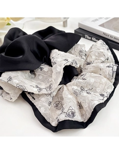 Detail of French floral scrunchie with black satin and white organza rose patterns
