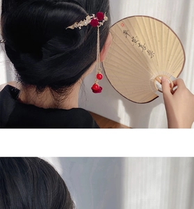Detailed view of Chinese hair pin featuring red roses and golden chain tassels with red beads