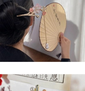 Detail of Chinese plum blossom hair stick with golden branch and pink flower tassels