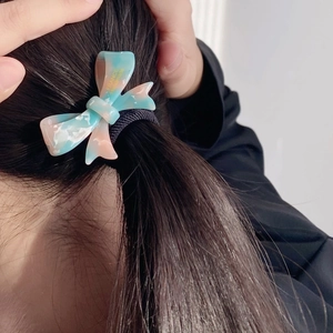 Elegant acetate bow hair tie with blue marble texture on high-elastic black rubber band