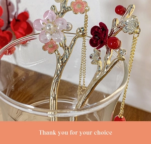 Detail of golden plum blossom hairpin with red flowers, pearls and beaded tassels