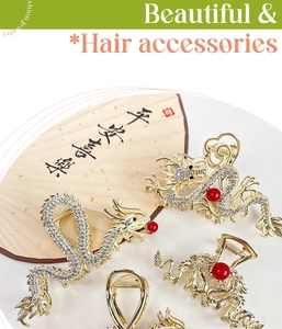 Detail view of dragon hair claw clips with sparkling rhinestones and red bead embellishment