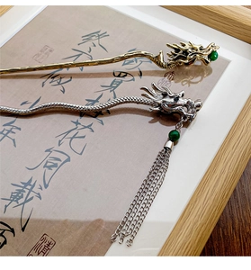 Detailed view of dragon hairpins with green beads and chain tassels in oriental style