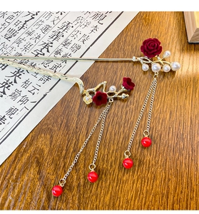 Detail of golden plum blossom hairpin with red velvet rose, pearls and long tassels