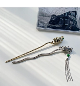 Detailed close-up of retro dragon hairpins with green beads and metallic tassels