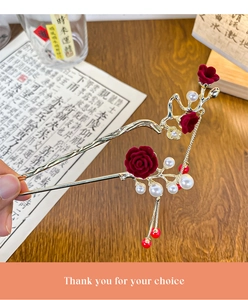 Detail of classic plum blossom hairpin with red velvet roses and gold metal tassels
