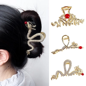 Elegant Chinese golden dragon hair claw clip with white rhinestones and red bead accents