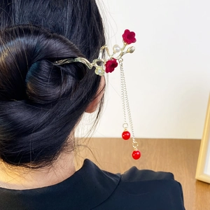Elegant gold plum blossom hair stick with red tassels and pearls in a traditional style