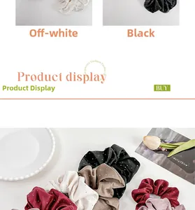 Close-up of satin scrunchies with fine rhinestones in cream, black, and burgundy colors