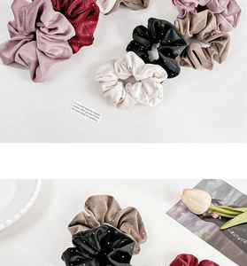 Macro detail of velvet scrunchies in various colors with sparkling silver glitter finish