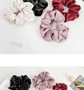 Detailed view of satin velvet scrunchies with sparkling rhinestones in four colors