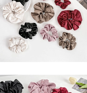 Detailed view of satin polka dot scrunchies in various vintage colors and textures