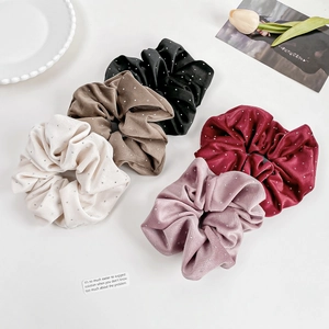 Five velvet scrunchies with rhinestones in cream, khaki, black, burgundy, and lotus pink