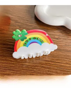 Macro view of a colorful rainbow hair claw clip with rhinestones and clover detail
