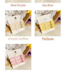 Detailed close-up of wavy macaron hairpins set in purple, blue, and pink colors