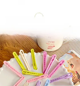 Detail showing wavy candy color hairpins set in vibrant matte pastel shades