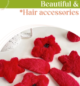 Detailed macro view of two red plush hair clips in star and oval shapes with soft fur texture