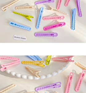 Detail showing colorful macaron wavy hair clips with a smooth matte lacquer finish